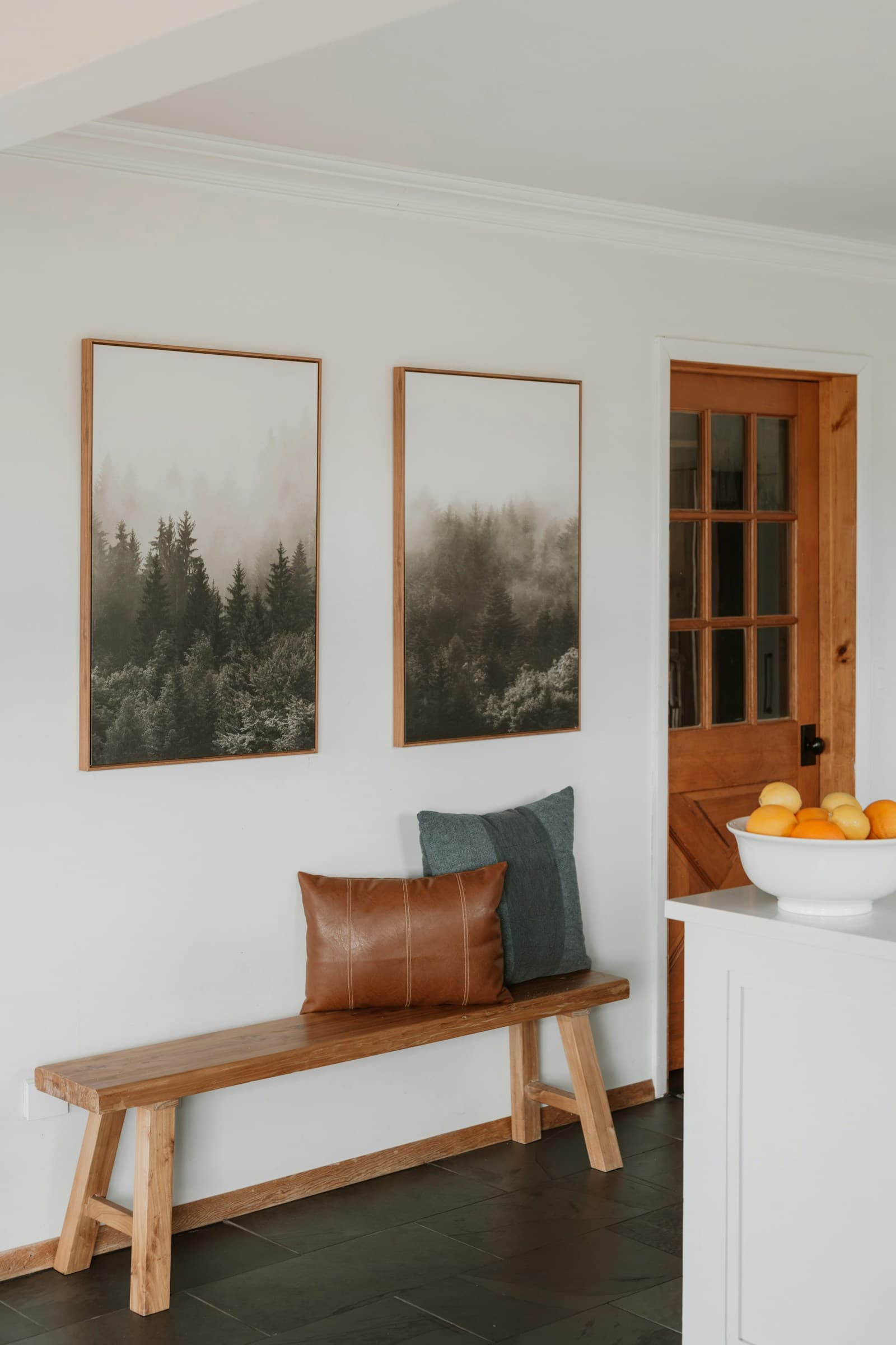 Wood entryway bench beside storage