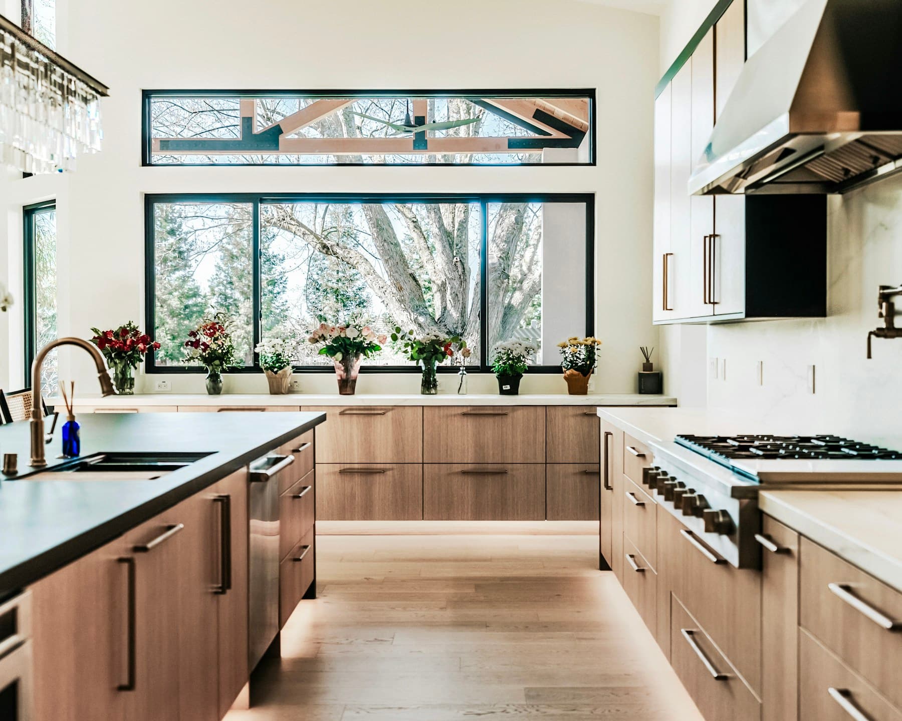 Wood kitchen cabinets with a large window and island