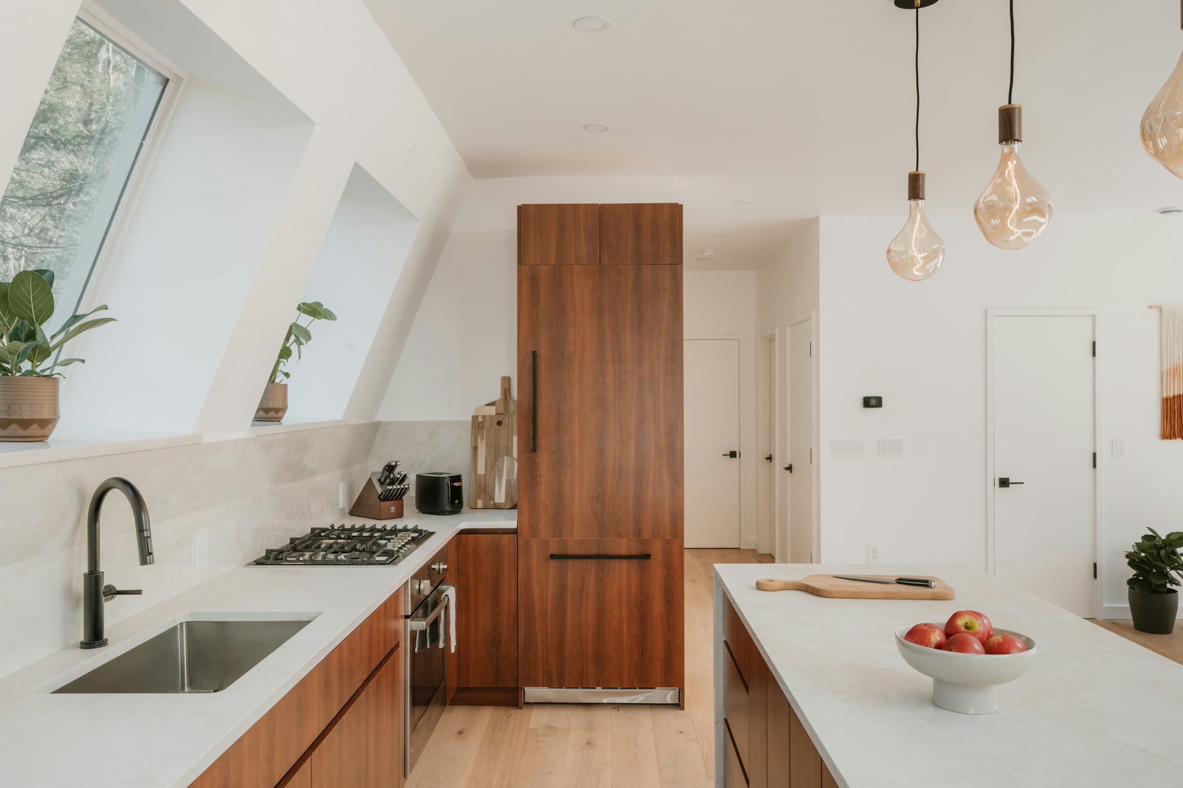 Warm wood kitchen cabinets and a generous island in a sunlit room